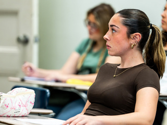 Graduate student in a classroom at Manhattan University