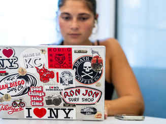 Graduate student studying with their laptop open at Manhattan University