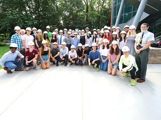Image of Walter Saukin, Ph.D. and engineering students standing together on campus.