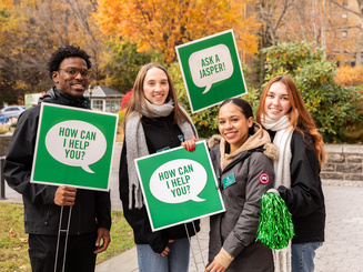 Manhattan University Admission counselors and students smiling during an open house event