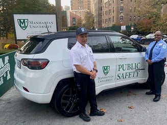 Public safety officers on campus next to their vehicle