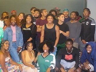 students gather in a group for a photo