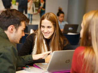 students working together on a laptop