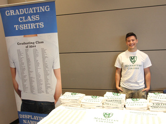 student stands at a grad fair booth