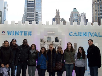 students gather to pose in front of the entrance to the Winter Carnival