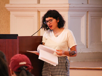 a person gives a speech near a lectern for Take Back the Night