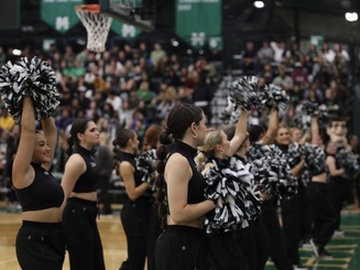 Manhattan University dancers perform on a basketball court