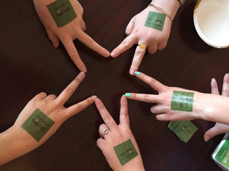 hands in a circle with two fingers out to form a five-pointed star