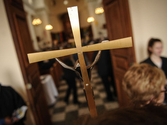 view of a cross as it is being carried into a chapel