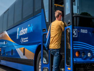 a person boards a HudsonLink bus