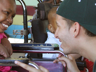 A student connects with a young woman on a service trip in Jamaica
