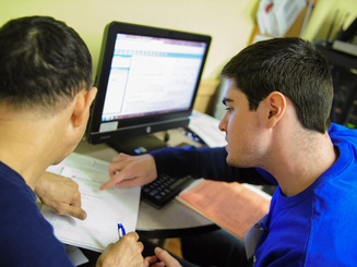 a student helps another person with a tax form