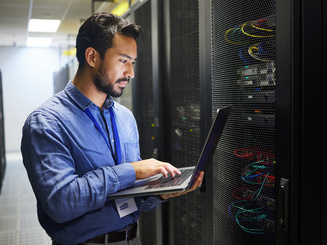 Man, engineering laptop and data center, server room inspection or system solution, coding and business network. IT person on computer for tech upgrade, gdpr programming and hardware problem solving