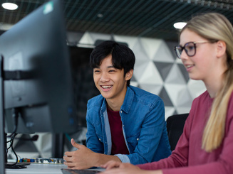 Manhattan University students looking at a monitor