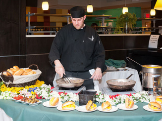 a chef prepares food for a buffet