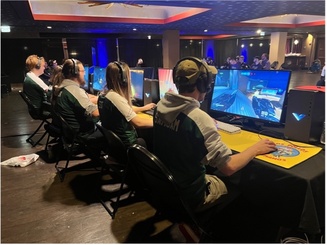 students compete at eSports while seated at computer tables