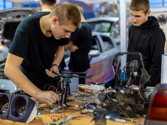 Young student learning automotive electronics engineering