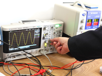 Engineer Operating a Digital Oscilloscope