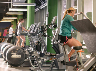 students exercise on fitness equipment