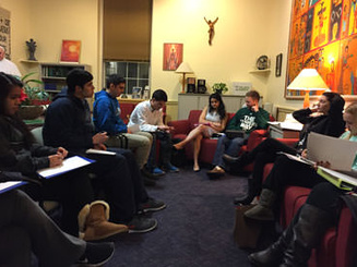 students meet in a circle to plan a retreat