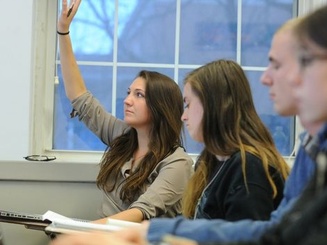 a student raises their hand in class