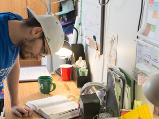 a student in their residence hall dorm room