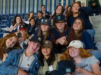 students and family attend a Yankees game