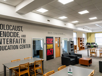 Photo inside the Library showing the The Holocaust, Genocide and Interfaith Education Center wall.