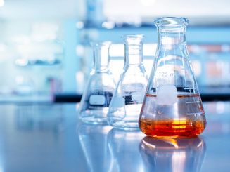 orange solution in glass beaker in a laboratory