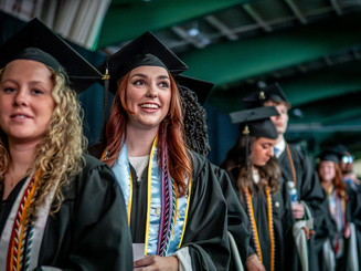 Manhattan University students walking during undergraduate commencement ceremony