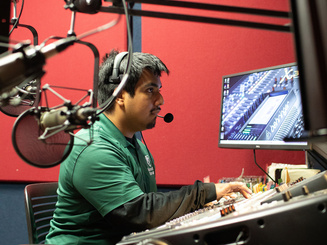 Manhattan University in a sound booth, working on a class exercise
