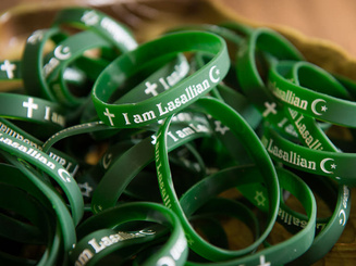 photo of a several rubber bracelets that say I am Lasallian Catholic