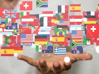 illustration of many countries flags floating about someones hand.