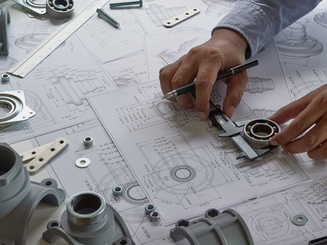 Engineer technician designing drawings mechanical parts engineering Engine.manufacturing factory Industry Industrial work project blueprints measuring bearings caliper tools