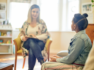 Counselor and person in a consultation in office for support and help