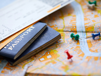pins marking travel itinerary points on map and passport