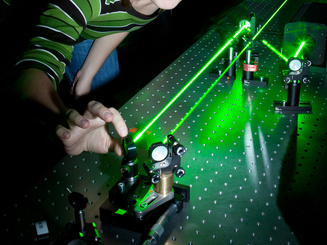female scientist doing research in a quantum optics lab