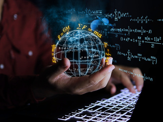 Physics scientist holds a globe to study laws of gravitational force with a computer