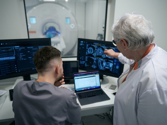doctor and her colleague are analyzing results of CT