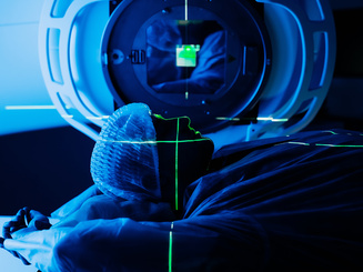 Linear accelerator in oncology treatment room, patient positioned for radiation therapy, with advanced technology