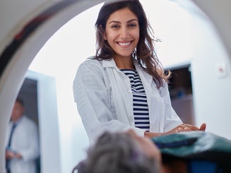 Doctor, mri and portrait of woman with patient to comfort in hospital for machine scanning. Ct scan, holding hands or smile of medical professional with senior person in radiology test for healthcare
