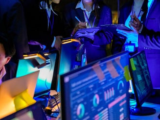 Diverse business professionals evaluating real-time metrics and project roadmaps together. 