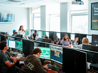 Photo showing the Bloomberg Lab in the O'Malley School of Business at Manhattan University with students and faculty