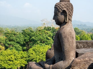 Buddha statue meditating at the Borobudur Temple in Indonesia
