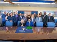 Manhattan College and Nassau Community College sitting together to sign the new articulation agreement