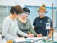 photo of 3 Manhattan University female students working in the chemical engineering lab