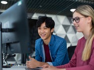 Manhattan University students looking at a monitor