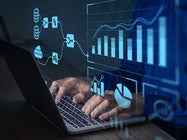 Analyst working with Business Analytics and Data Management System on computer to make report with KPI and metrics connected to database.