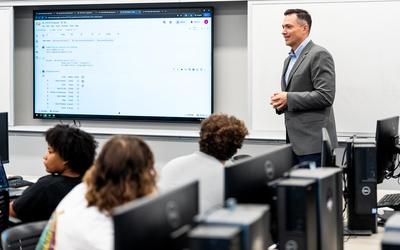 Manhattan University professor teaching business analytics in a classroom