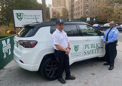 Public safety officers on campus next to their vehicle